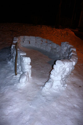 An after-hours shot of the snow walls being built above.